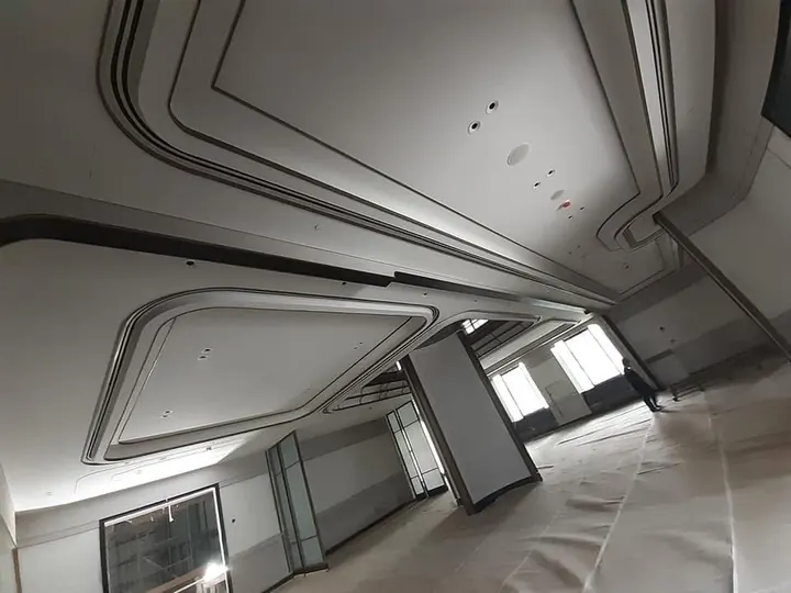 Linear slots following curved ceiling coves